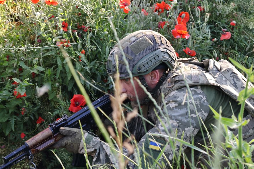 In this photo provided by Ukraine's 65th Mechanized Brigade press service, a soldier practices military skills at a training ground near the frontline in the Zaporizhzhia region, Ukraine, Thursday, June 11, 2026. (Andriy Andriyenko/Ukraine's 65th Mechanized Brigade via AP)