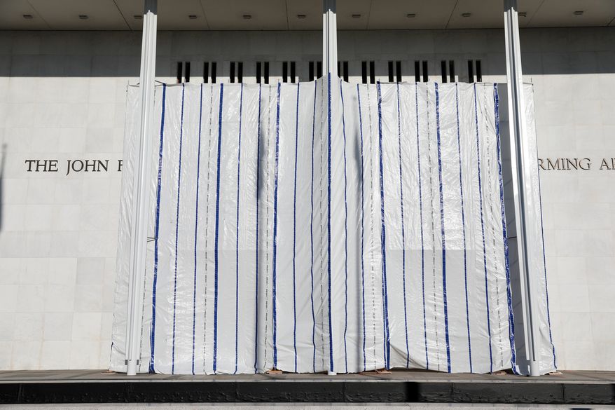 The wall of the John F. Kennedy Center for the Performing Arts is covered in tarp after President Donald Trump's name was removed, in Washington, Saturday, June 13, 2026. (AP Photo/Rahmat Gul)