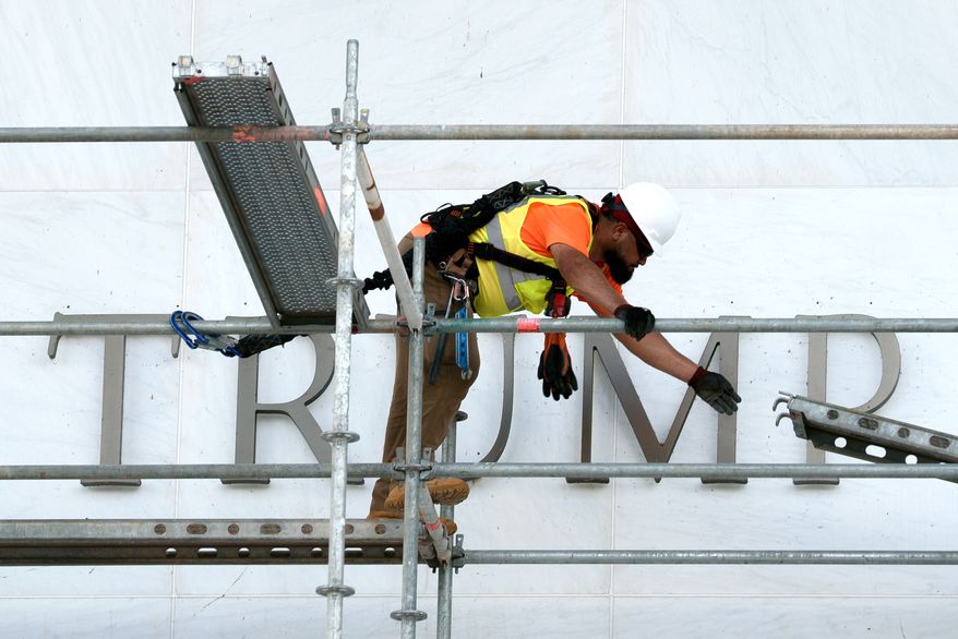 A worker constructs scaffolding in front of the John F. Kennedy Center for the Performing Arts sign in Washington, Friday, June 12, 2026. (AP Photo/Cliff Owen)