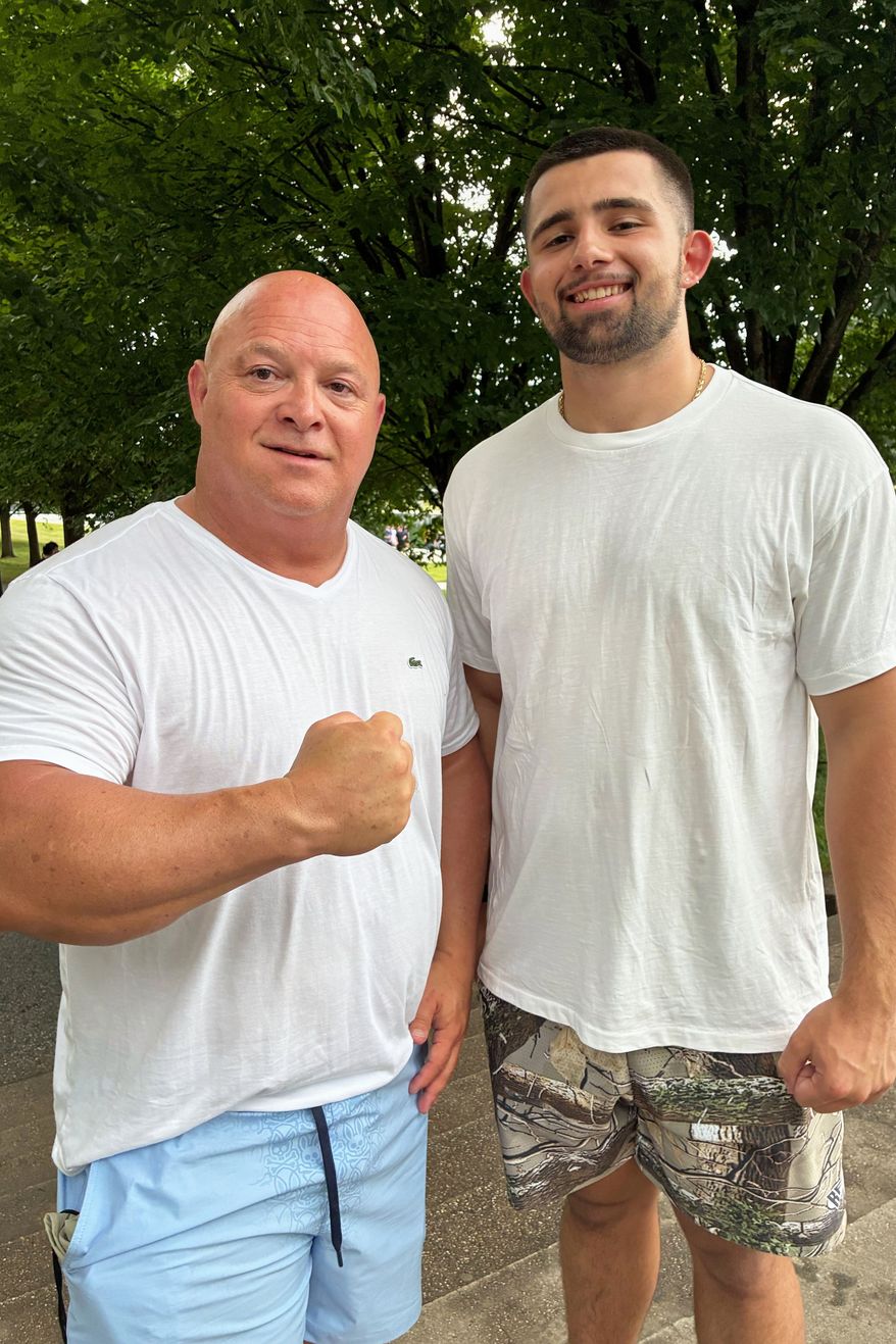 Tracy Philbeck and his son, Levi Philbeck, from Charlotte, N.C., pose for a photo at the Lincoln Memorial, Friday, June 12, 2026, in Washington. (AP Photo/Fatima Hussein)