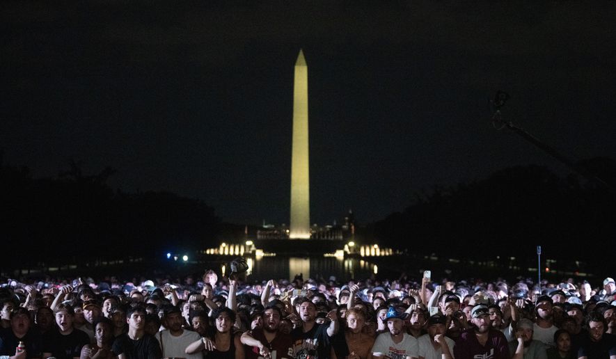 Audience members cheer and boo during a UFC news conference at the Lincoln Memorial, ahead of Sunday's fight on the South Lawn of the White House, Friday, June 12, 2026, in Washington. (AP Photo/Allison Robbert)