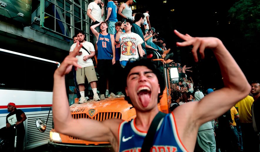 New York Knicks fans celebrate their victory after Game 5 of the NBA Finals basketball series against the San Antonio Spurs, Saturday, June 13, 2026, in New York. (AP Photo/Heather Khalifa)