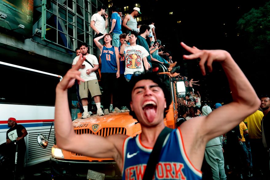 New York Knicks fans celebrate their victory after Game 5 of the NBA Finals basketball series against the San Antonio Spurs, Saturday, June 13, 2026, in New York. (AP Photo/Heather Khalifa)