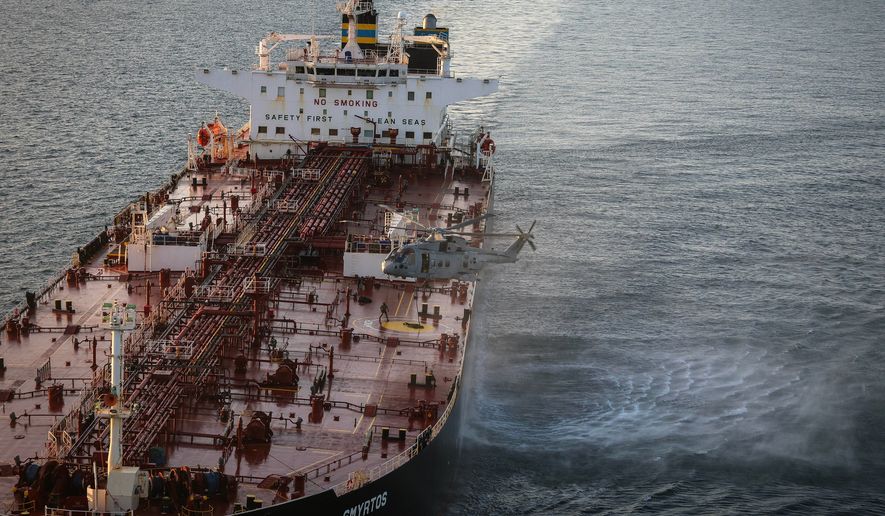 In this photo provided by the Royal Navy, Royal Marine Commandos detain sanctioned tanker, the Smyrtos, in the English Channel, Sunday, June 14, 2026. (LPhot Hutchins/Royal Navy via AP)