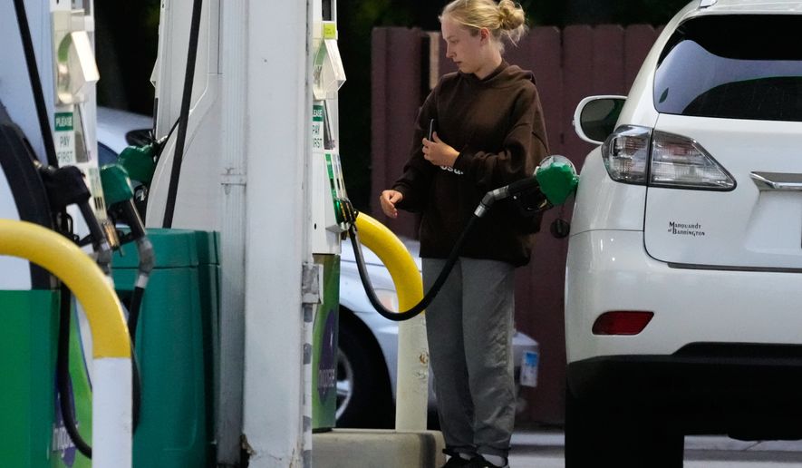 Customer checks gas price before she fills up her vehicle's tank at a gas station in Lincolnshire, Ill., Monday, June 8, 2026. (AP Photo/Nam Y. Huh) **FILE**