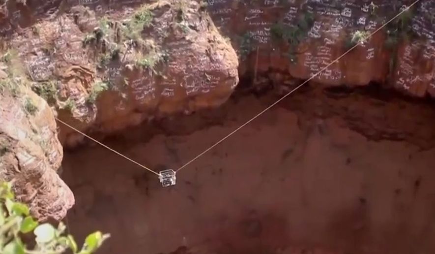 This screengrab from video, released by Yemeni Civil Defense Authority, shows rescuers removing the body of daredevil adventurer Al-Qaqa Ibn Antar on Saturday, June 13, 2026, after he had fallen into a volcanic crater in southern Yemen while climbing without safety equipment on Friday. (Yemeni Civil Defense Authority via AP)