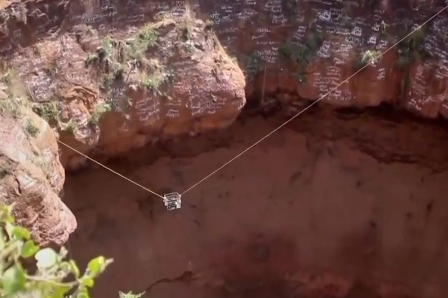 This screengrab from video, released by Yemeni Civil Defense Authority, shows rescuers removing the body of daredevil adventurer Al-Qaqa Ibn Antar on Saturday, June 13, 2026, after he had fallen into a volcanic crater in southern Yemen while climbing without safety equipment on Friday. (Yemeni Civil Defense Authority via AP)