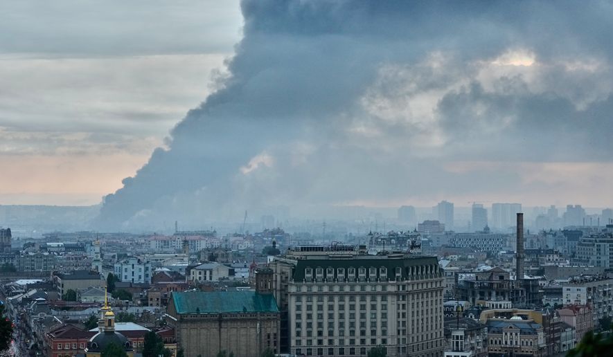 Smoke raises above the city in sunrise following a Russian air attack in Kyiv, Ukraine, Monday, June 15, 2026. (AP Photo/Efrem Lukatsky)