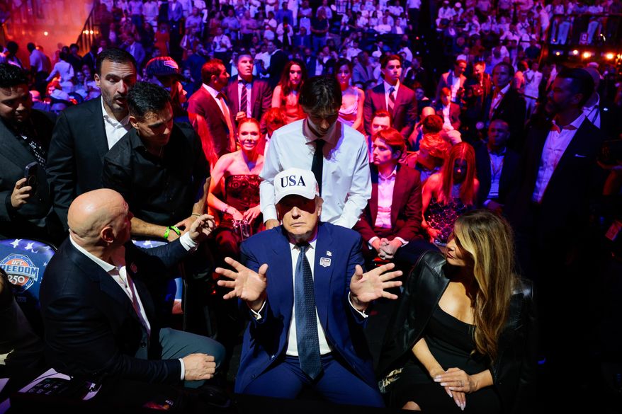 President Donald Trump, center, gestures as he attends UFC Freedom 250 alongside UFC President and CEO Dana White, left, and first lady Melania Trump on the South Lawn of the White House in Washington, Monday, June 15, 2026. (Evan Vucci/Pool Photo via AP)