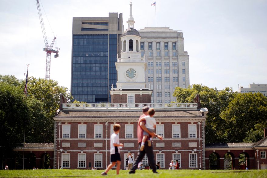 People move past Independence Hall at the Independence National Historical Park in Philadelphia, Aug. 25, 2016. (AP Photo/Matt Rourke, File)