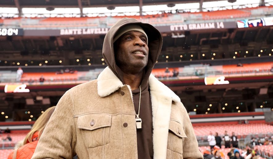University of Colorado head coach Deion Sanders stands on the sidelines prior to the start of an NFL football game between the Cleveland Browns and the Tennessee Titans, Sunday, Dec. 7 2025, in Cleveland. (AP Photo/Kirk Irwin, File)