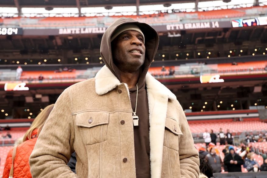 University of Colorado head coach Deion Sanders stands on the sidelines prior to the start of an NFL football game between the Cleveland Browns and the Tennessee Titans, Sunday, Dec. 7 2025, in Cleveland. (AP Photo/Kirk Irwin, File)