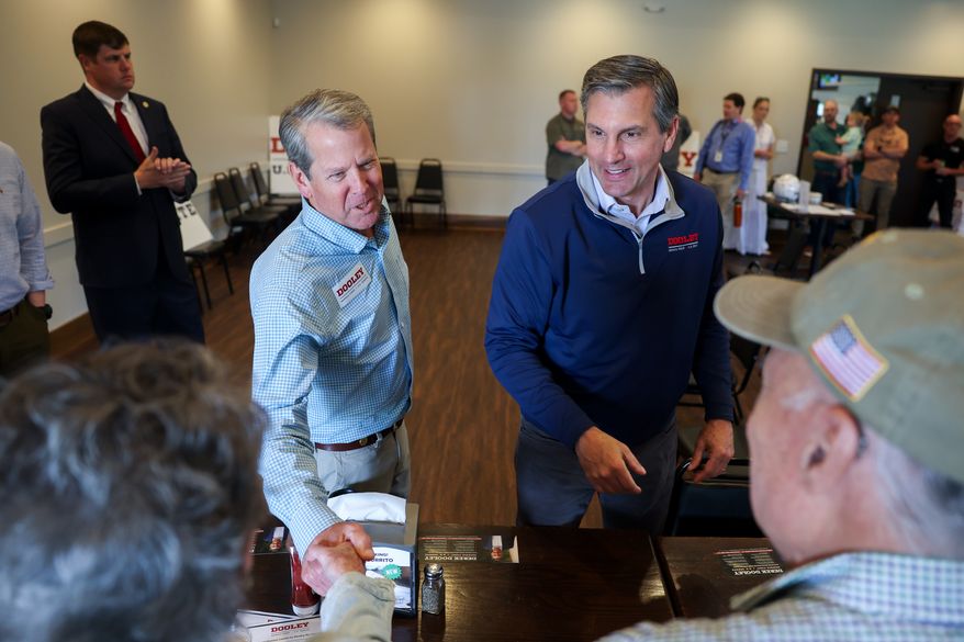 Gov. Brian Kemp, center left, and Republican U.S. Senate candidate Derek Dooley greet supporters at campaign stop for Dooley at Farmview Market in Madison, Ga., on May 8, 2026. (Arvin Temkar/Atlanta Journal-Constitution via AP, File)