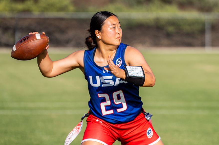 This photo provided by USA Football shows Akemi Higa, a player for the women’s national flag football team, winding up to pass at a USA Football training camp in Chula Vista, Calif., Friday, April 17, 2026. (Mina Creamer/USA Football via AP)