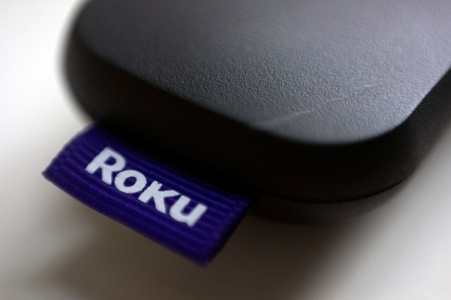 This Aug. 13, 2020, file photo shows a logo for Roku on a remote control in Portland, Ore. (AP Photo/Jenny Kane, file)