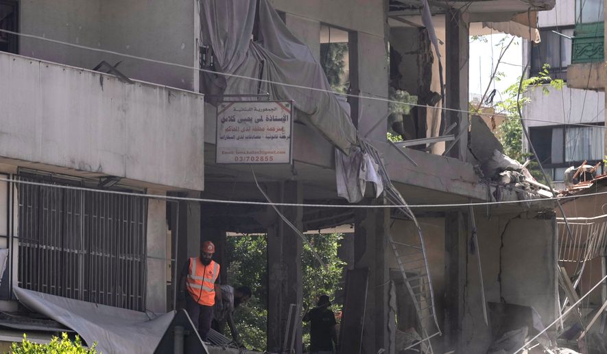 A rescue worker checks an apartment that was hit in an Israeli airstrike in Dahiyeh, Beirut's southern suburbs, Lebanon, Sunday, June 14, 2026. (AP Photo/Bilal Hussein)