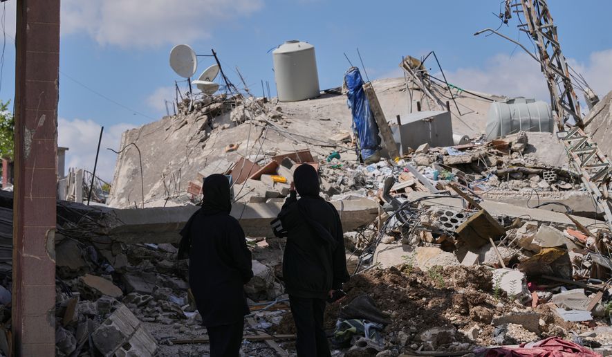 People who return to their village following the announcement of an initial ceasefire agreement between the United States and Iran, check their destroyed house in Deir Qanoun village, south Lebanon, Monday, June 15, 2026.(AP Photo/Mohammed Zaatari)