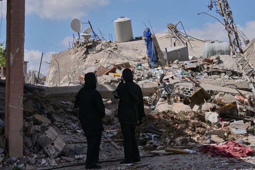 People who return to their village following the announcement of an initial ceasefire agreement between the United States and Iran, check their destroyed house in Deir Qanoun village, south Lebanon, Monday, June 15, 2026.(AP Photo/Mohammed Zaatari)