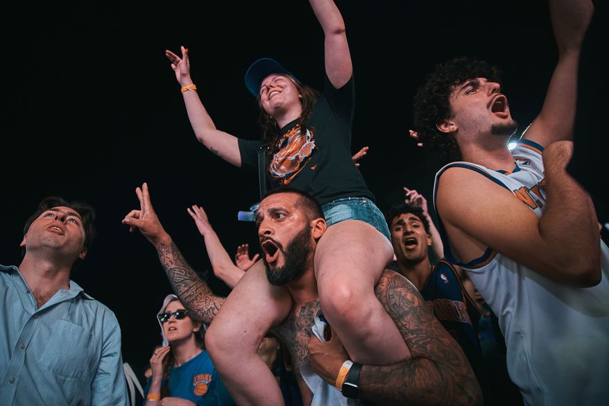 New York Knicks fans celebrate as they watch Game 5 of the NBA Finals basketball series against the San Antonio Spurs, Saturday, June 13, 2026, in New York. (AP Photo/Andres Kudacki)