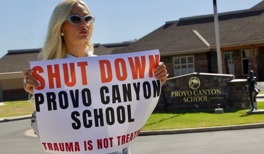 Paris Hilton protests outside the Provo Canyon School, where she says she suffered abuse as a teen, Monday, June 15, 2026, in Springville, Utah. (AP Photo/Hannah Schoenbaum)