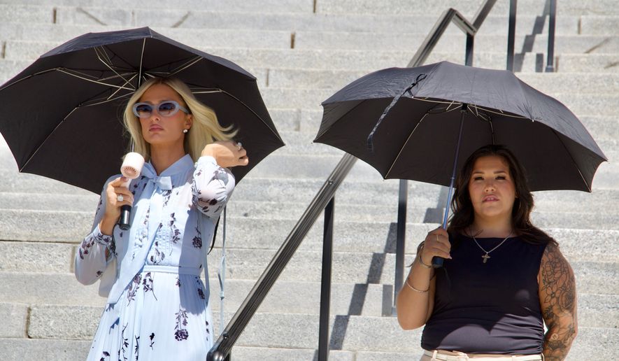 Paris Hilton, left, stands alongside Aleah Corona, the mother of a student injured at the Provo Canyon School, during a news conference Monday, June 15, 2026, in Provo, Utah. (AP Photo/Hannah Schoenbaum)