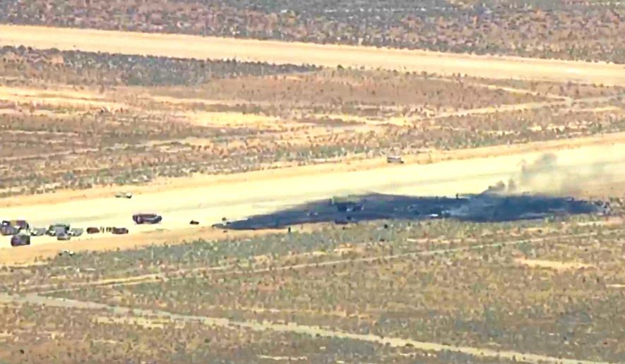 This image taken from video provided by KABC shows law enforcement responding to the scene of an aircraft crash, Monday, June 15, 2026, near Edwards Air Force Base, Calif. (KABC via AP)