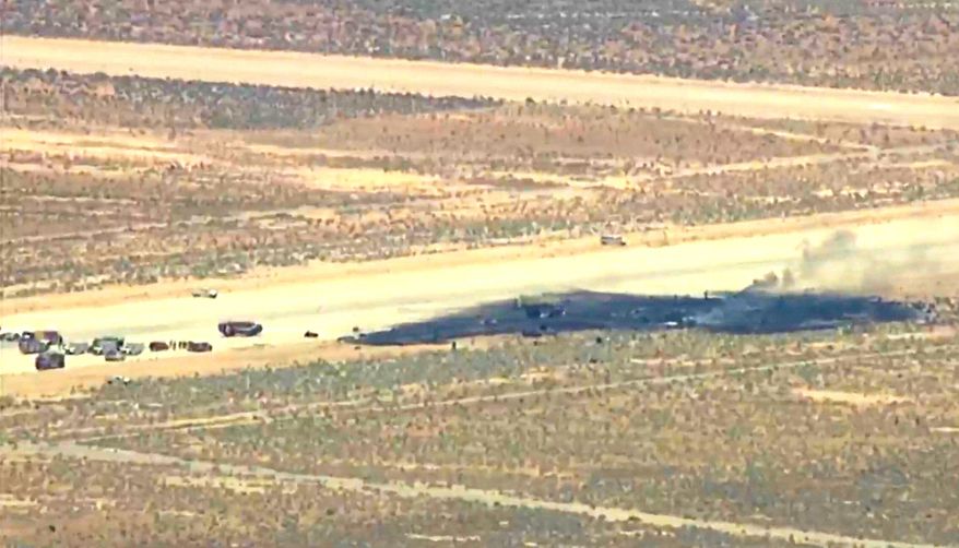 This image taken from video provided by KABC shows law enforcement responding to the scene of an aircraft crash, Monday, June 15, 2026, near Edwards Air Force Base, Calif. (KABC via AP)