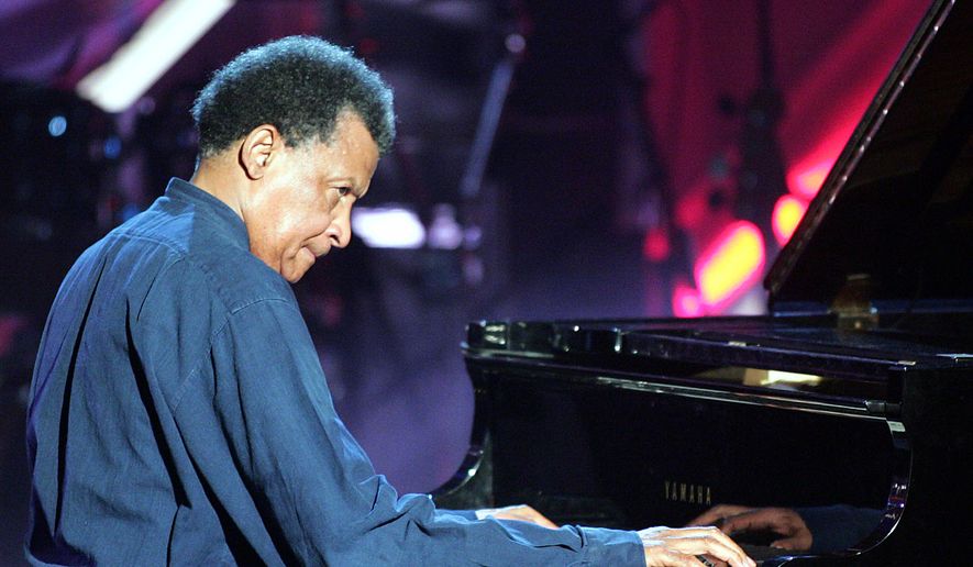 Musician Abdullah Ibrahim plays on a grand piano during the Adolf-Grimme awards gala in Marl, western Germany, March 18, 2005. (AP Photo/Martin Meissner, File)