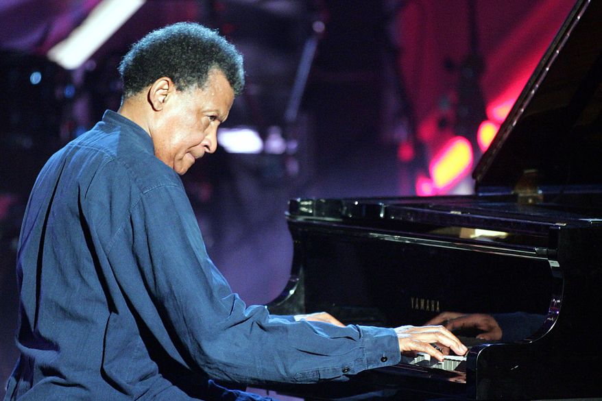 Musician Abdullah Ibrahim plays on a grand piano during the Adolf-Grimme awards gala in Marl, western Germany, March 18, 2005. (AP Photo/Martin Meissner, File)