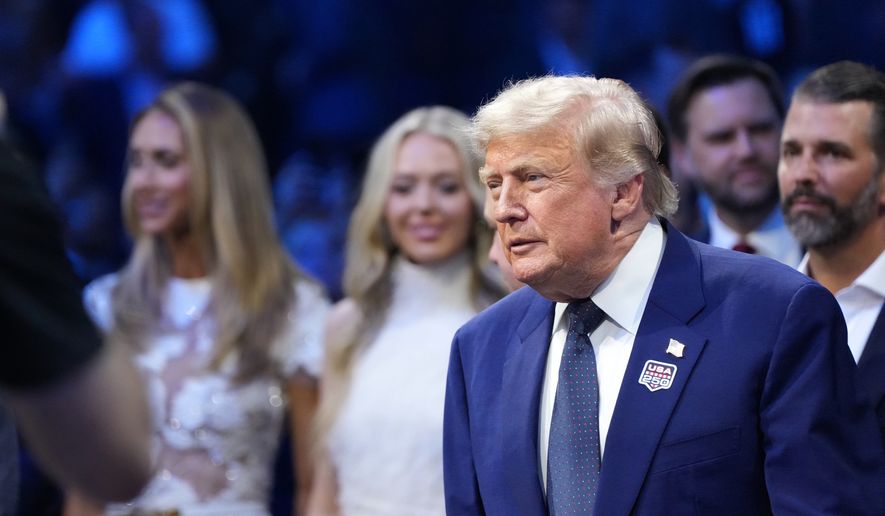 President Donald Trump attends the UFC Freedom 250 on the South Lawn of the White House, Sunday, June 14, 2026, in Washington with Lara Trump, Tiffany Trump and Donald Trump Jr. (AP Photo/Alex Brandon)