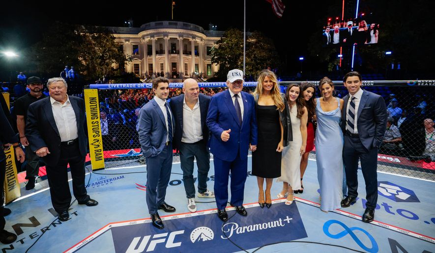 President Donald Trump, first lady Melania Trump, UFC President and CEO Dana White and other guests pose inside the octagon after UFC Freedom 250 on the South Lawn of the White House, Monday, June 15, 2026, in Washington. (Evan Vucci/Pool Photo via AP)