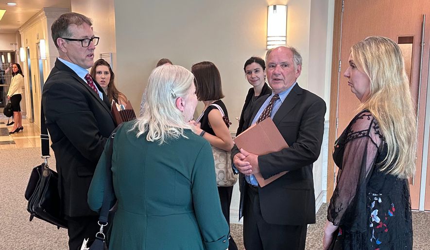 Jim Troupis, former campaign attorney for President Donald Trump, second from right, speaks with a group including his attorney Joe Bugni, left, after pleading not guilty to several felony forgery counts related to the 2020 fake elector scheme Tuesday, June 16, 2026, in Madison, Wis. (AP Photo/Scott Bauer)