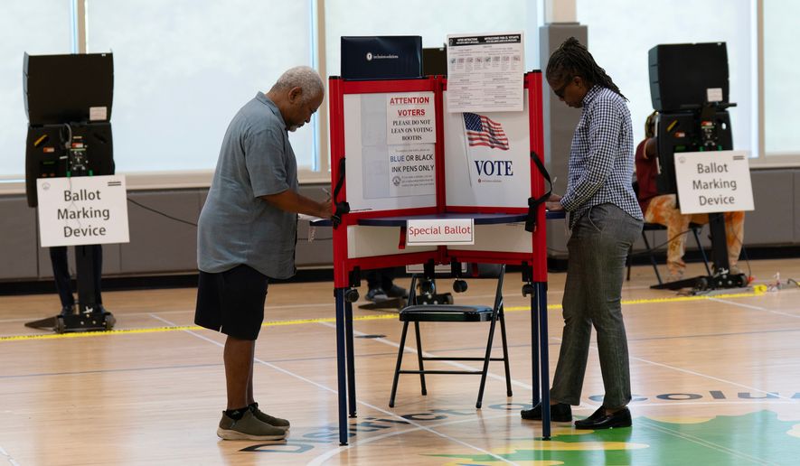 People cast their vote during the D.C. primary election at Shepard Park Elementary, Tuesday, June 16, 2026, in Washington. (AP Photo/Jose Luis Magana)