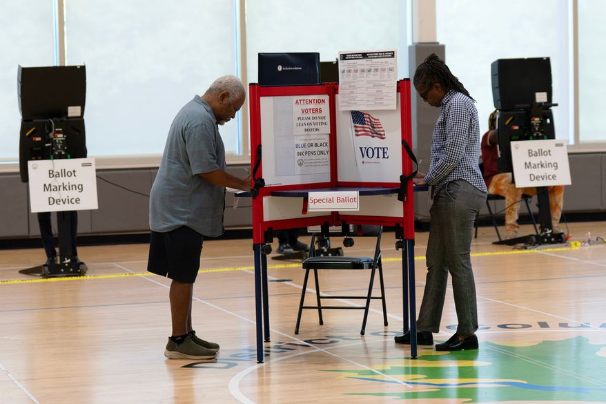 People cast their vote during the D.C. primary election at Shepard Park Elementary, Tuesday, June 16, 2026, in Washington. (AP Photo/Jose Luis Magana)