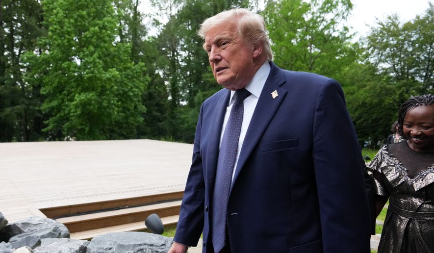U.S. President Donald Trump walks away after a group photo of leaders at the G7 summit, Tuesday, June 16, 2026, in Evian-les-Bains, France. (AP Photo/Julia Demaree Nikhinson)