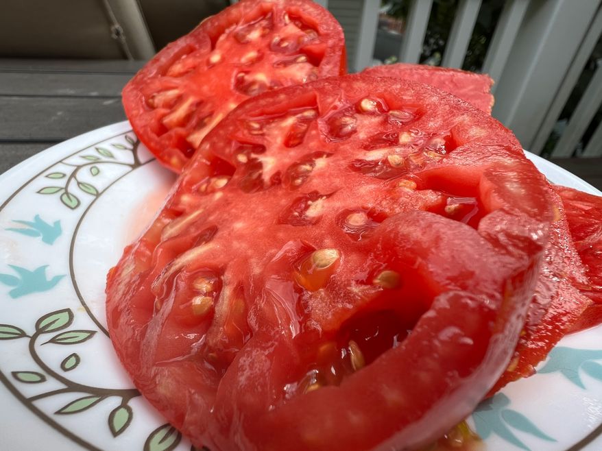 A halved Brandywine tomato appears at a home on Long Island, N.Y. on July 31, 2024. (Jessica Damiano via AP)