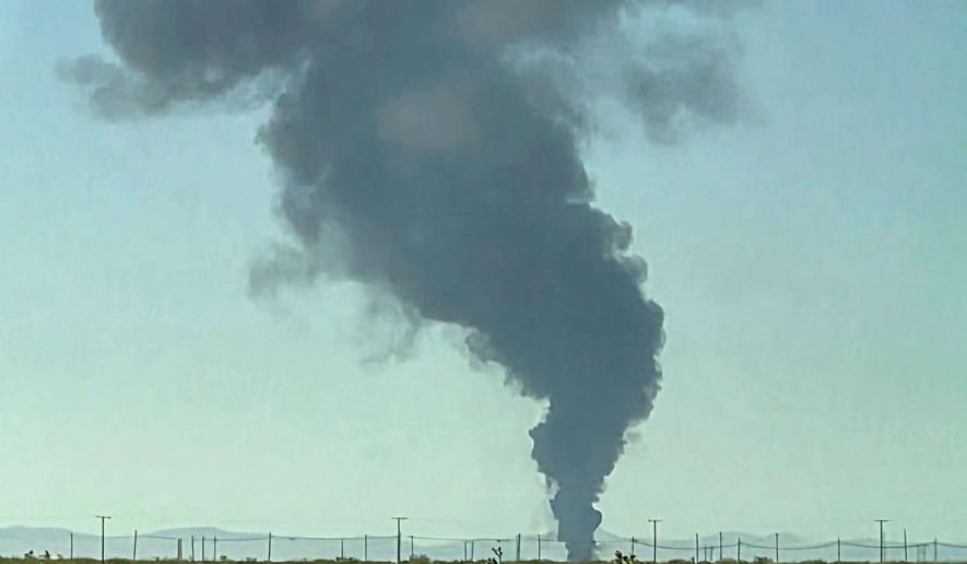 Smoke plumes rise from a B-52 bomber that crashed shortly after takeoff at a U.S. Air Force base in Southern California, Monday, June 15, 2026. (Debbie Reyes Katz via AP Photo)