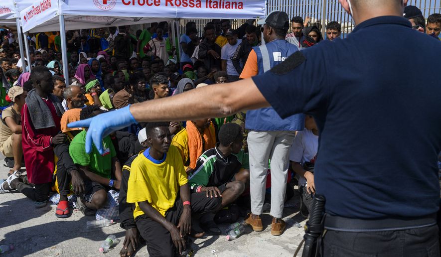 Migrants wait to be transferred from Lampedusa Island, Italy, Sept. 15, 2023. Albania has agreed to host two migrant processing centers on its territory that will be run by Italy under a deal that worries human rights activists. The European Union, however, sees it as a possible future template. (AP Photo/Valeria Ferraro) **FILE**