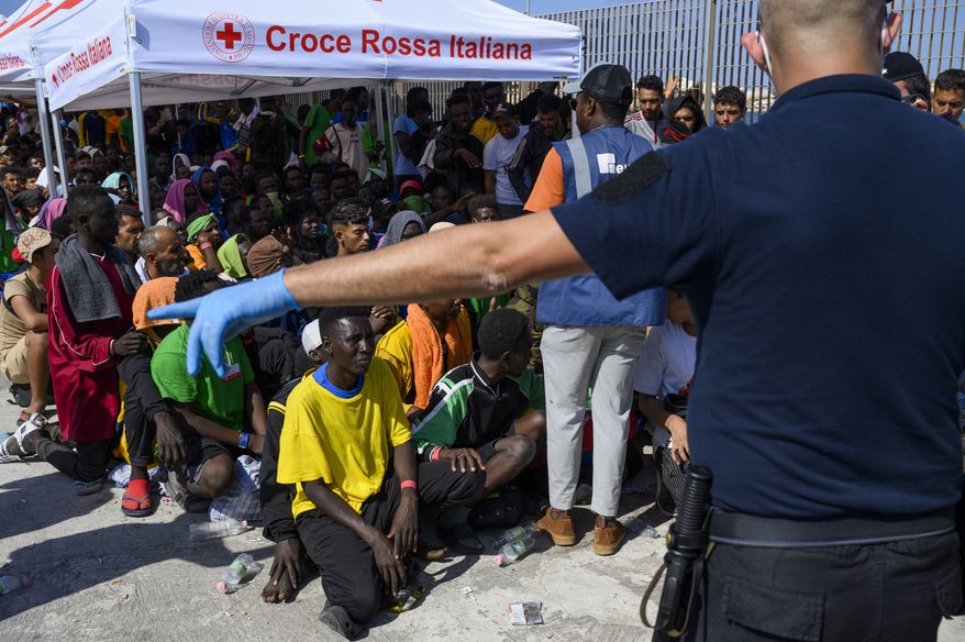 Migrants wait to be transferred from Lampedusa Island, Italy, Sept. 15, 2023. Albania has agreed to host two migrant processing centers on its territory that will be run by Italy under a deal that worries human rights activists. The European Union, however, sees it as a possible future template. (AP Photo/Valeria Ferraro) **FILE**