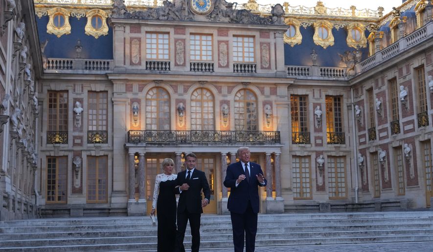 U.S. President Donald Trump is greeted by French President Emmanuel Macron and and first lady Brigitte Macron as he arrives at the Palace of Versailles, Wednesday, June 17, 2026, in Versailles, France. (AP Photo/Julia Demaree Nikhinson)