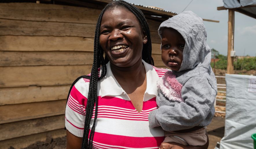 Kahindo Mireille Pierrette, an Ebola survivor poses with her 16-month old baby, after they were declared to have survived Ebola and discharged from the Rwampara treament Center in Ituri Congo, Tuesday, June 16, 2026. (AP Photo/Moses Sawasawa)