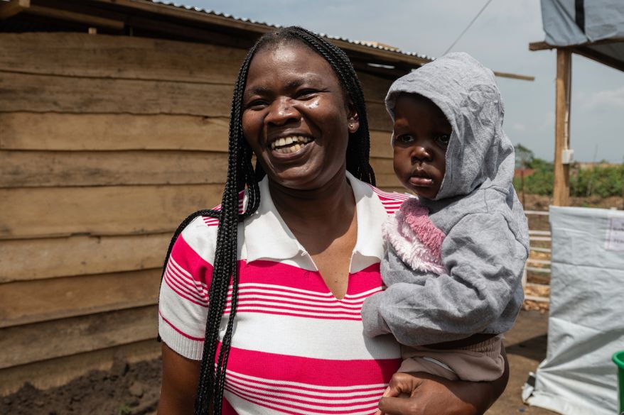 Kahindo Mireille Pierrette, an Ebola survivor poses with her 16-month old baby, after they were declared to have survived Ebola and discharged from the Rwampara treament Center in Ituri Congo, Tuesday, June 16, 2026. (AP Photo/Moses Sawasawa)