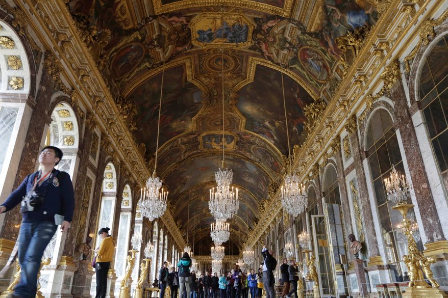 FILE - Visitors walk inside the Hall of Mirrors in the Versailles castle, on Nov. 17, 2015 in Versailles, west of Paris. (AP Photo/Amr Nabil, File)