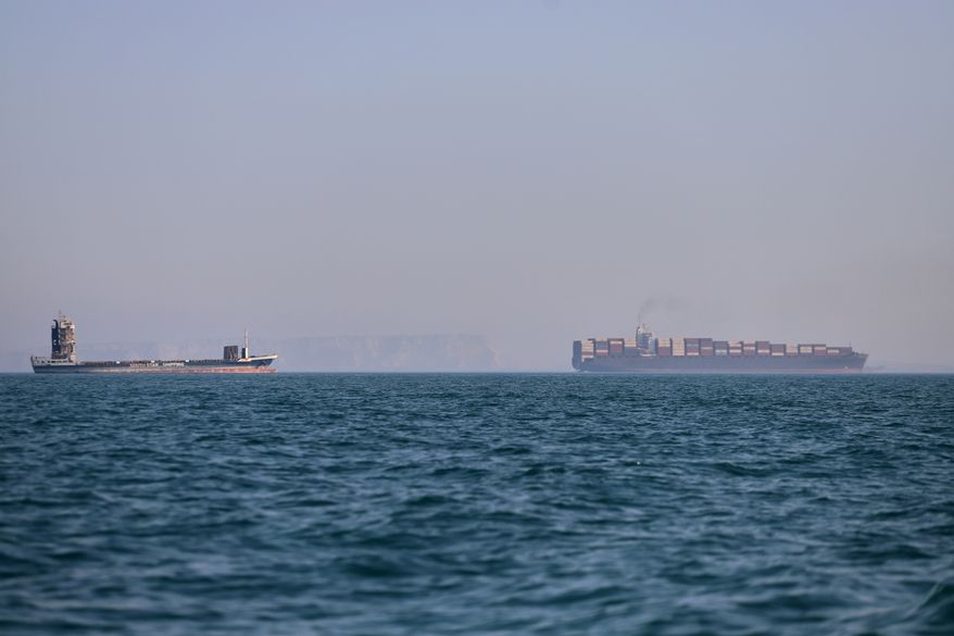 A container ship, right, and a cargo vessel are seen in the Strait of Hormuz off Bandar Abbas, Iran, Wednesday, June 17, 2026. (Amirhosein Khorgooi/ISNA via AP)