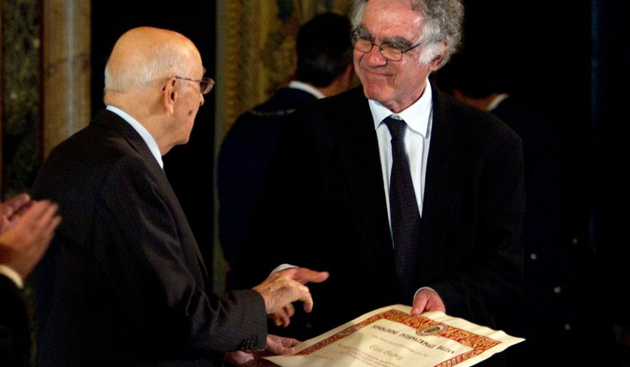 FILE - Then-Italian President Giorgio Napolitano, left, awards Italian professor Carlo Ginzburg with the "Balzan" prize, in Rome's Quirinale presidential palace, Friday, Nov. 19, 2010. (AP Photo/Andrew Medichini, File)