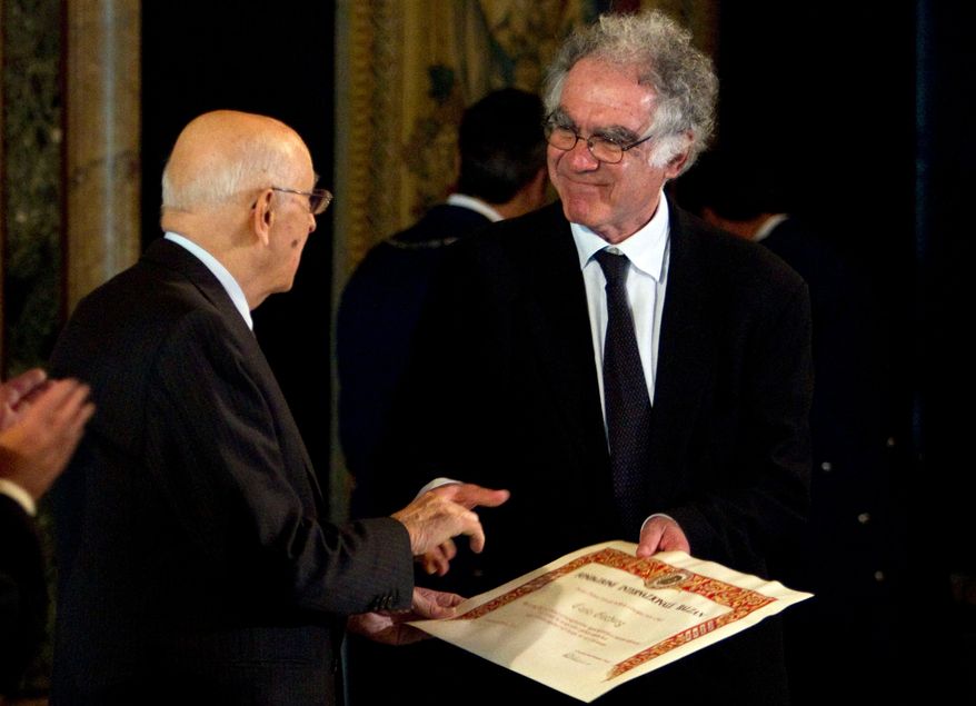FILE - Then-Italian President Giorgio Napolitano, left, awards Italian professor Carlo Ginzburg with the "Balzan" prize, in Rome's Quirinale presidential palace, Friday, Nov. 19, 2010. (AP Photo/Andrew Medichini, File)