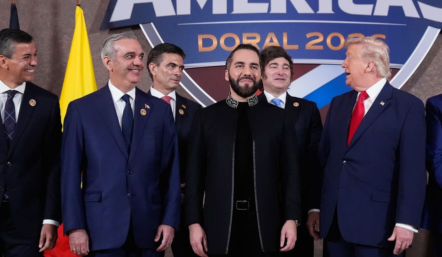 FILE - President Donald Trump poses for a group photo with, from left, Paraguay President Santiago Peña, Dominican Republic President Luis Abinader, Bolivia President Rodrigo Paz Pereira, El Salvador President Nayib Bukele, and Argentina President Javier Milei, at the Shield of the Americas Summit at Trump National Doral Miami in Doral, Fla., March 7, 2026. (AP Photo/Mark Schiefelbein, File)