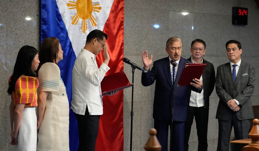 New Senate President Sherwin Gatchalian, third from left, takes his oath during a special session at the Philippine Senate in Pasay city, Philippines on Wednesday, June 17, 2026. (AP Photo/Aaron Favila)