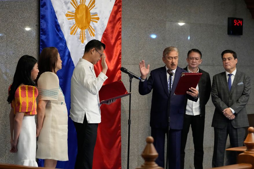 New Senate President Sherwin Gatchalian, third from left, takes his oath during a special session at the Philippine Senate in Pasay city, Philippines on Wednesday, June 17, 2026. (AP Photo/Aaron Favila)