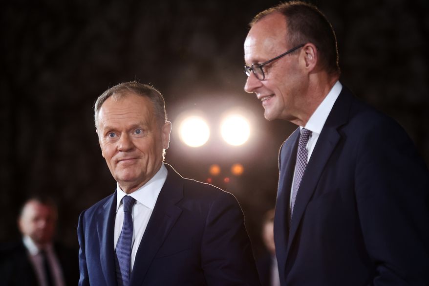 FILE - German Chancellor Friedrich Merz welcomes Polish Prime Minister Donald Tusk at the Chancellery in Berlin on Dec. 15, 2025. (AP Photo/Maryam Majd, File)